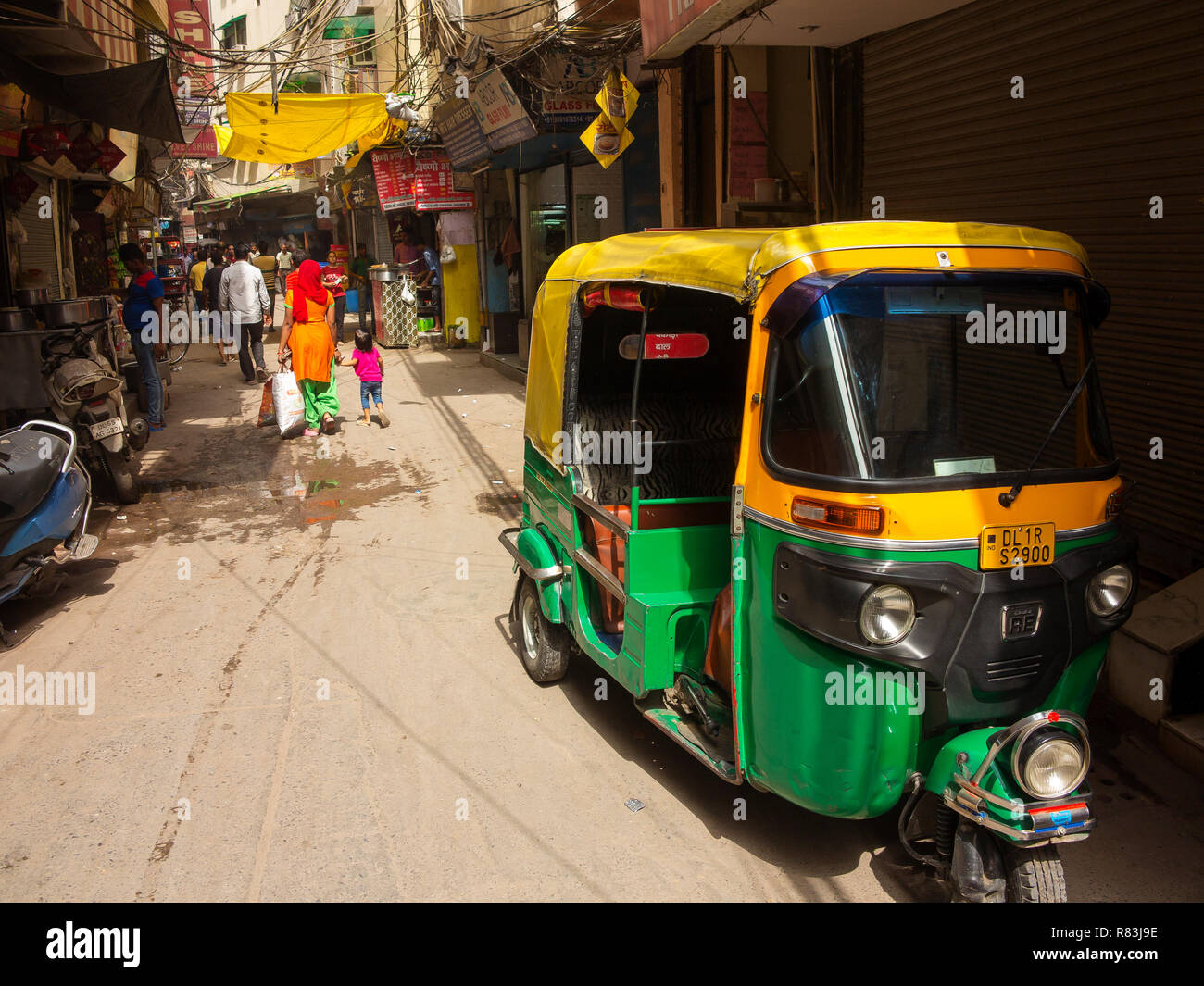 Street scene at Sangatrashan Bazar, Tuk Tuks the indian taxis at the narrow streets, New Delhi, India Stock Photo