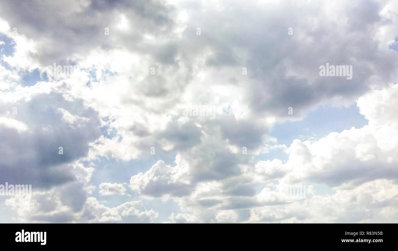 cumulus clouds like fluffy, white cotton balls on the blue sky