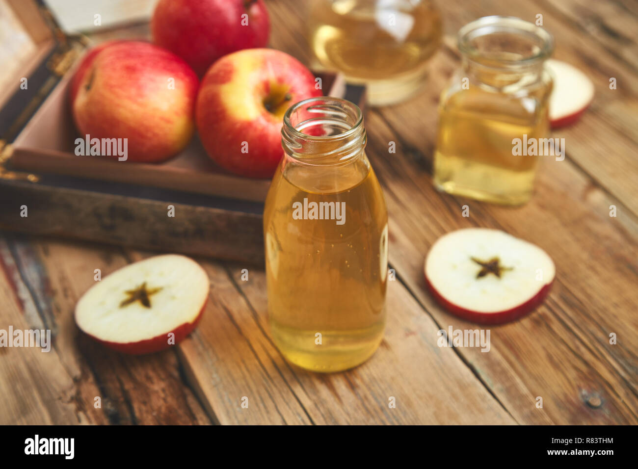 Apple cider vinegar. Glass Bottle of apple organic vinegar on wooden