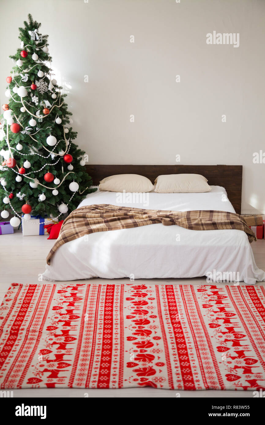 Christmas bedrooms with bed tree gifts new year postcard Stock Photo