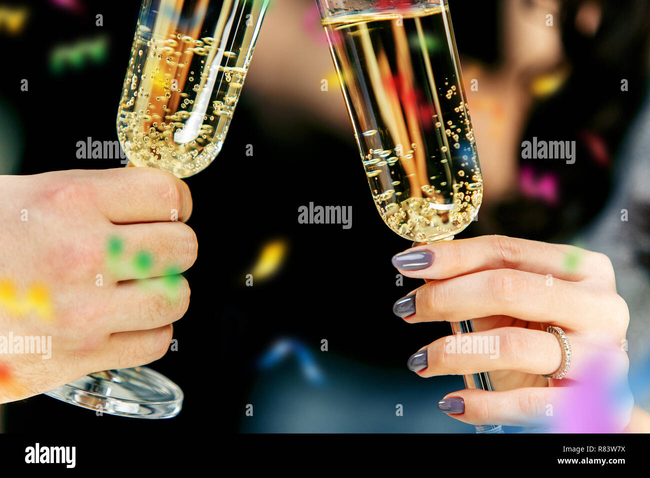 Celebration. Hands holding the glasses of champagne and wine making a ...