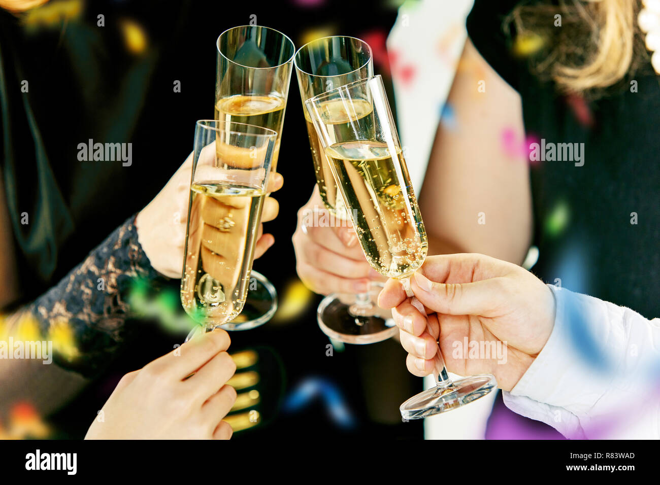 Celebration. Hands holding the glasses of champagne and wine making a ...