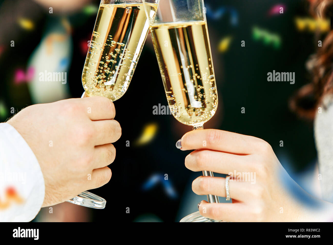 Celebration. Hands holding the glasses of champagne and wine making a ...