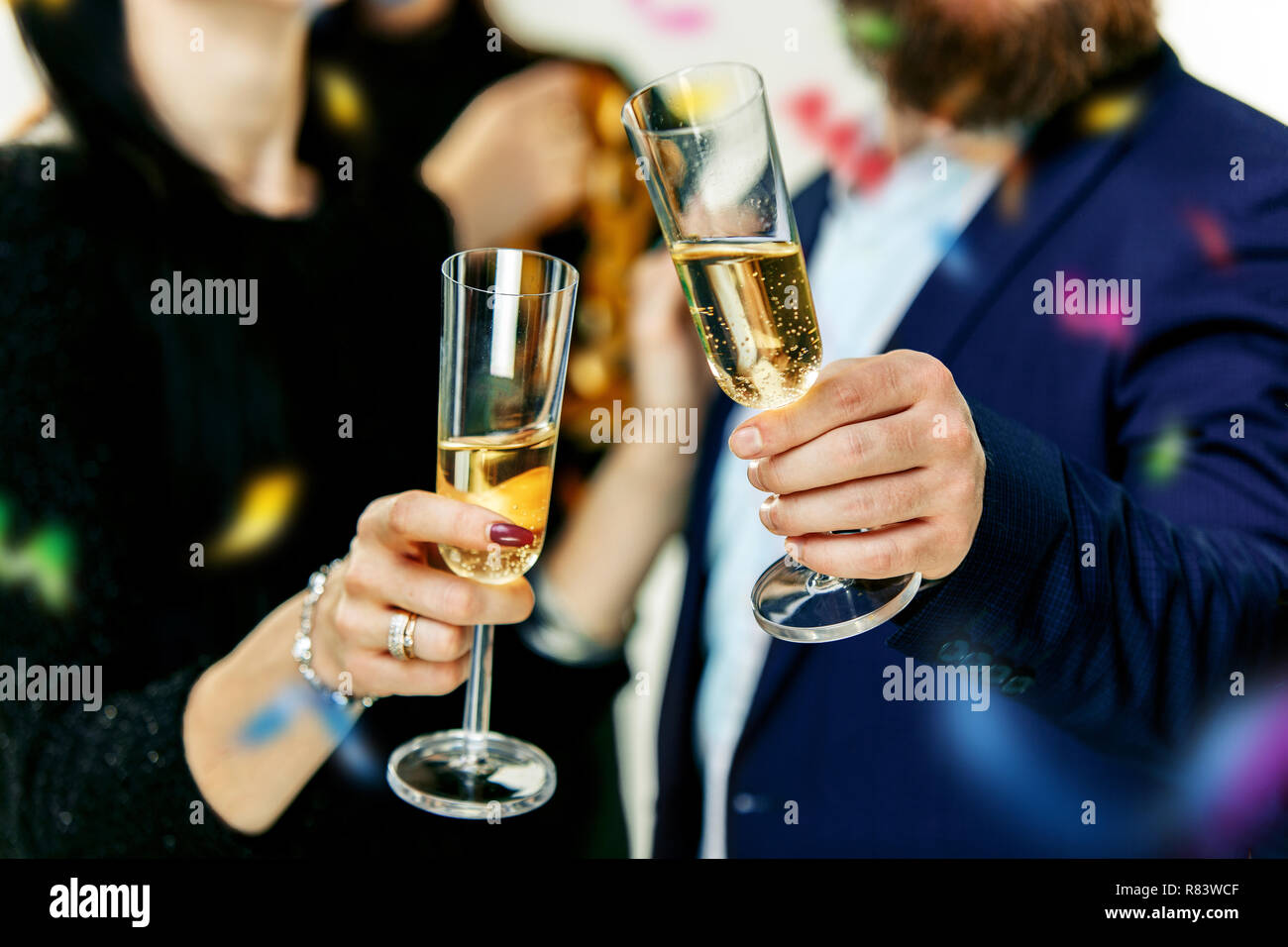 Celebration. Hands holding the glasses of champagne and wine making a ...