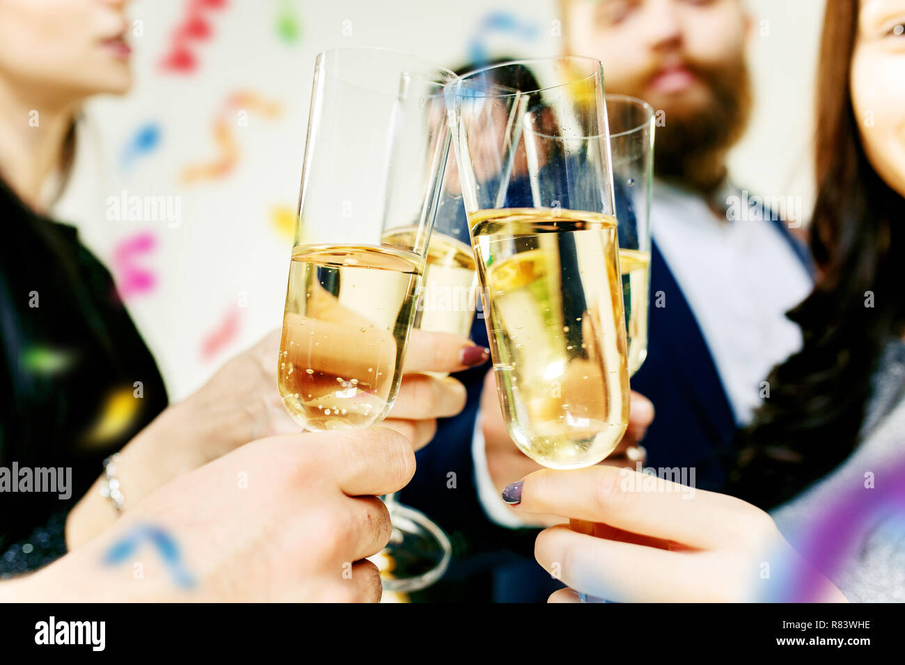 Celebration. Hands holding the glasses of champagne and wine making a ...