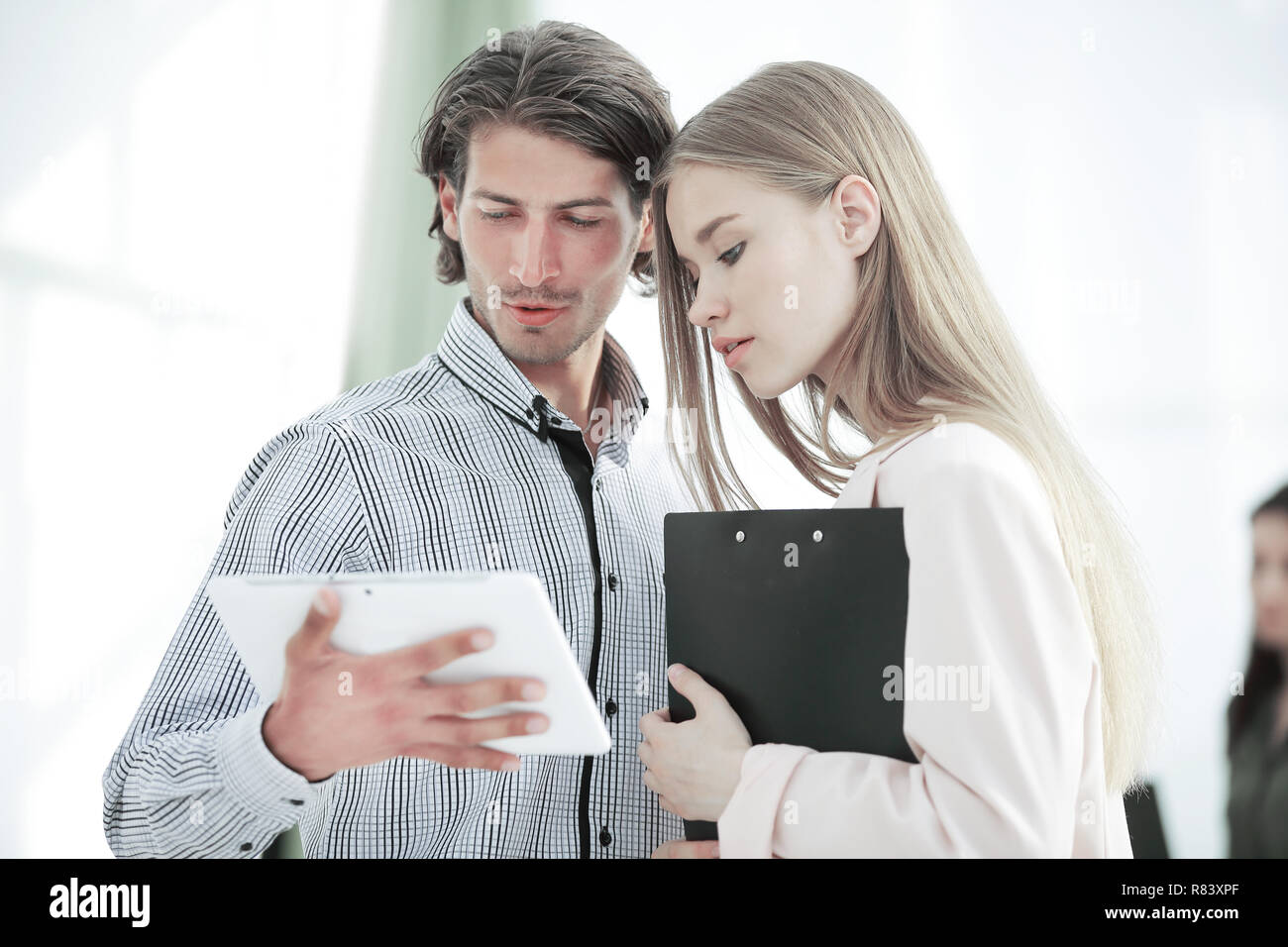 Office workers looking at tablet computer. people and technology. Stock Photo