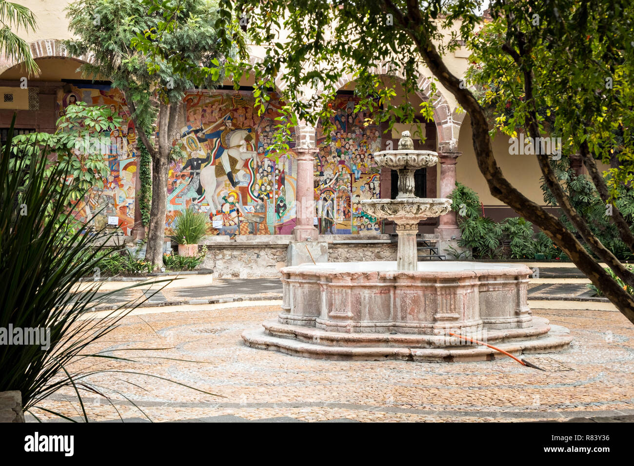 Interior courtyard with fountain at the Instituto Allende in San Miguel de Allende, Mexico. The mural in the background is by legendary Mexican muralist David Alfaro Siqueiros. Stock Photo