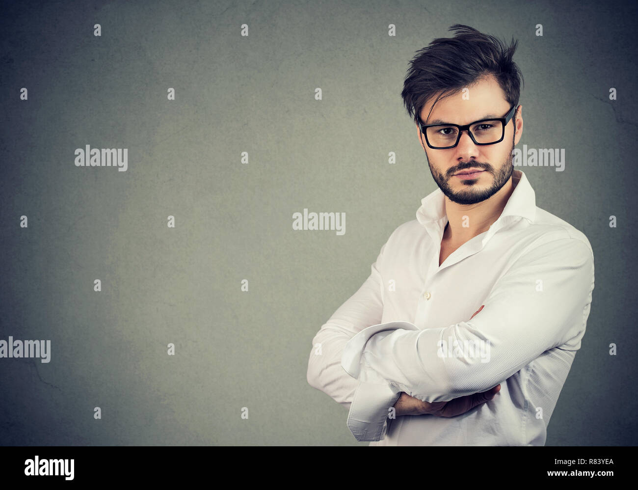 Cool Young Man With Beard Wearing Glasses And White Shirt Looking