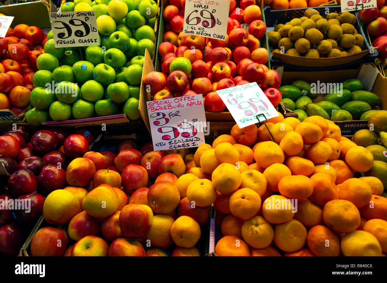 Assorted apples Kiwi Fruit and seedless oranges for sale on greengrocer