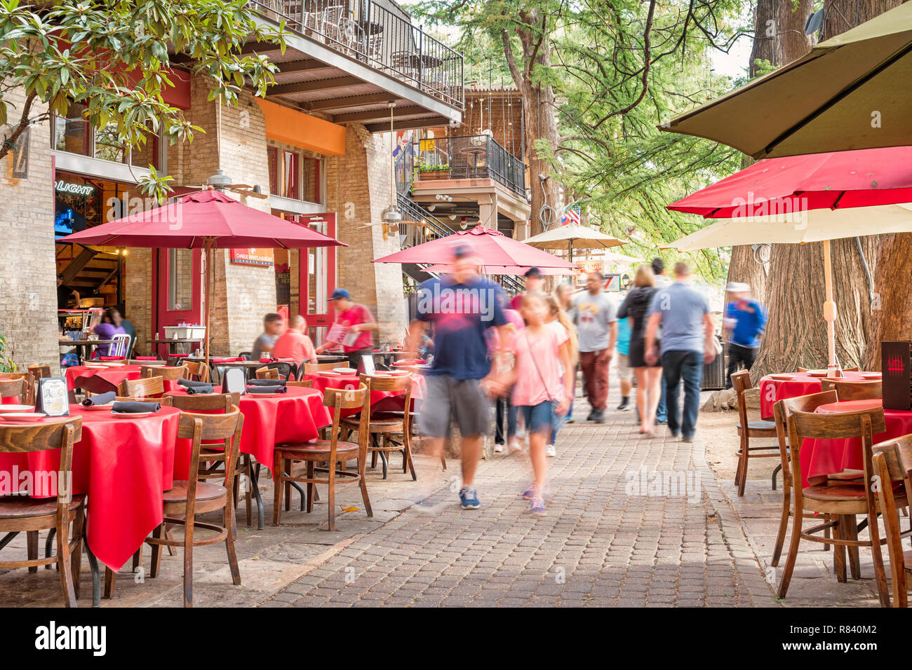 People Walk Past Restaurant Patios At The San Antonio River Walk