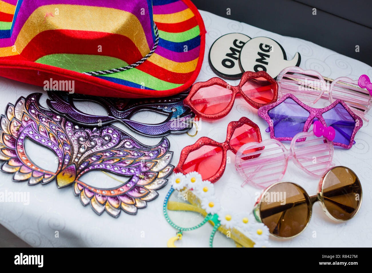 Photo booth props including funny glasses, masks, signs, and colorful hats. Stock Photo