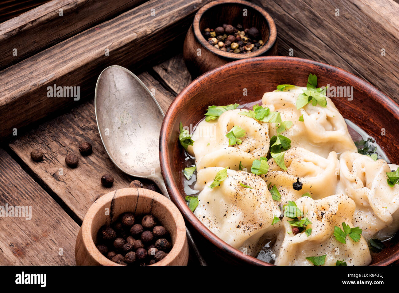 Traditional Russian dish pelmeni.Meat dumplings on wooden rustic background Stock Photo