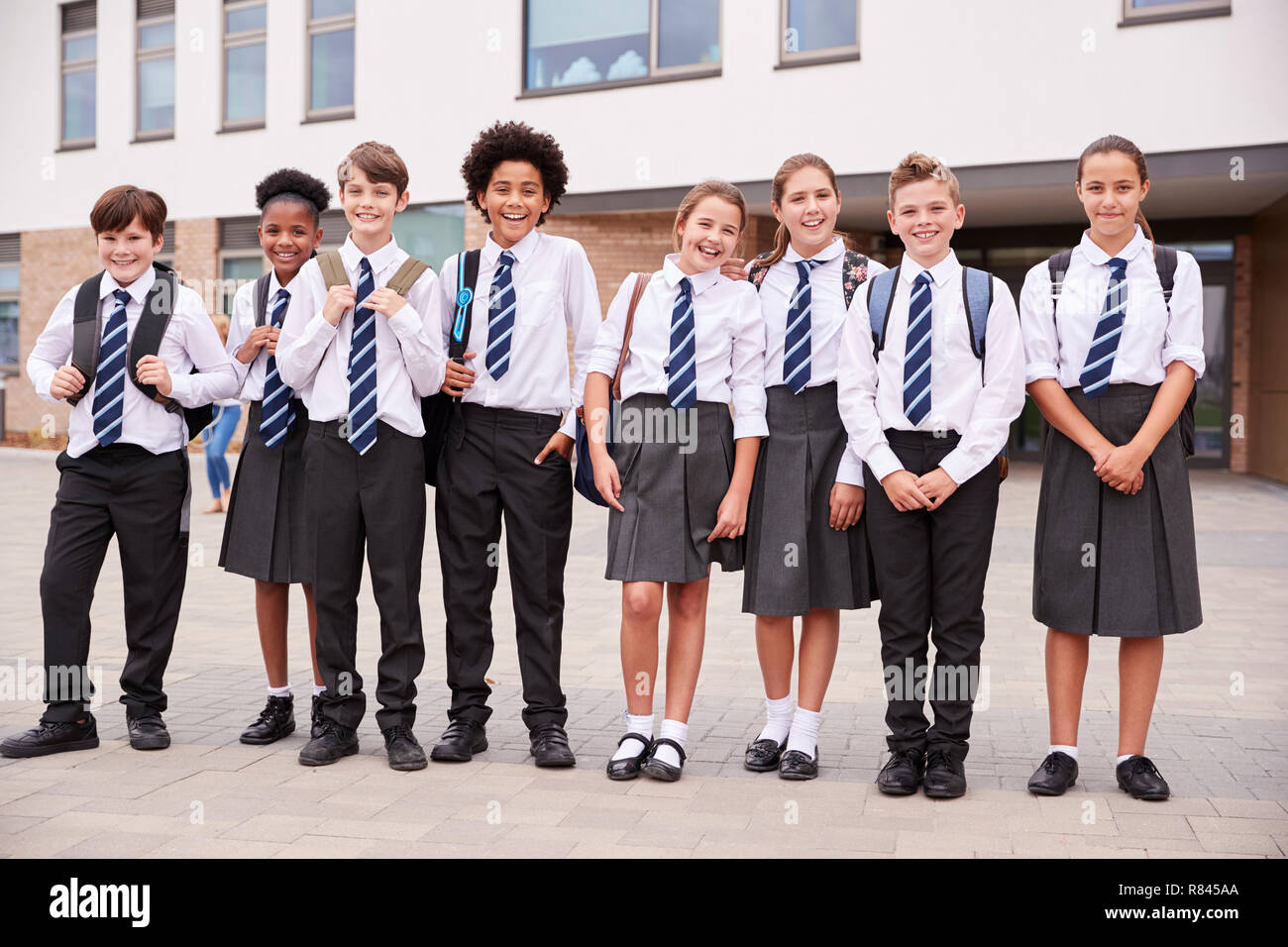 Portrait Of High School Student Group Wearing Uniform Standing Outside School Buildings Stock Photo