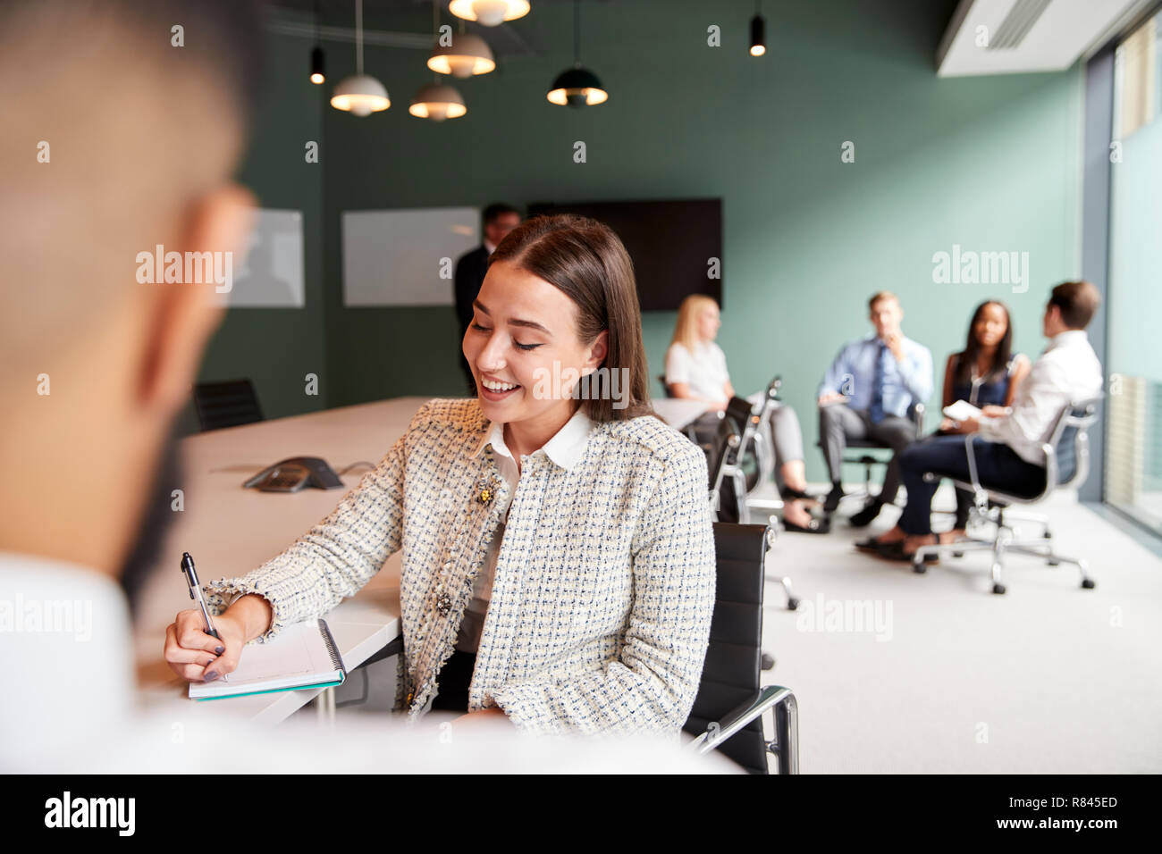 Businesswoman And Businessman Collaborating On Task Together At Graduate Recruitment Assessment Day Stock Photo