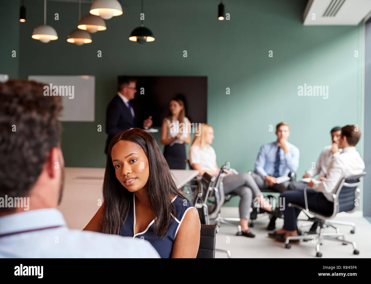 Businesswoman And Businessman Collaborating On Task Together At Graduate Recruitment Assessment Day Stock Photo