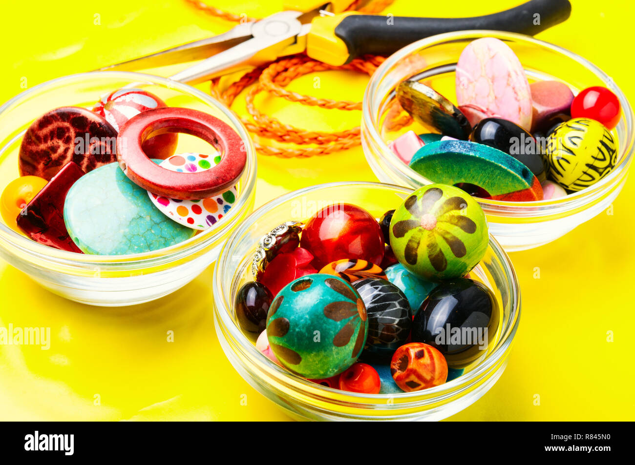 Jewelry making and beading process.Colored beads on yellow background Stock Photo Alamy