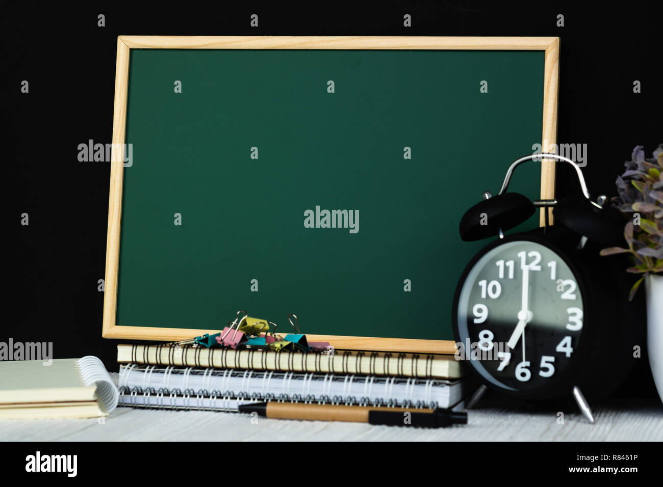 Back to school and education concept idea, green chalkboard with pile ...