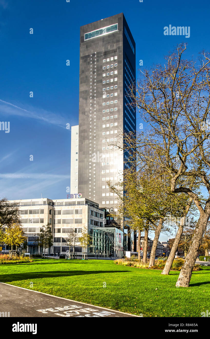 Leeuwarden, The Netherlands, November 3, 2018: the Achmea tower, the city's only real highrise building, against a blue sky in autumn Stock Photo