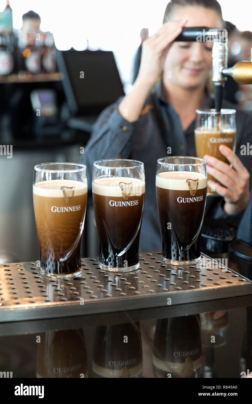 Ireland, Dublin, Guinness Storehouse, Gravity Bar, bartender pouring beer. Stock Photo