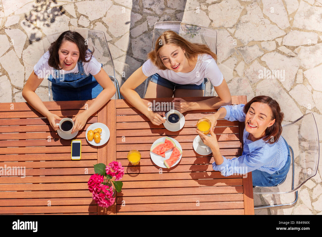 Happy family having breakfast at street cafe Stock Photo - Alamy