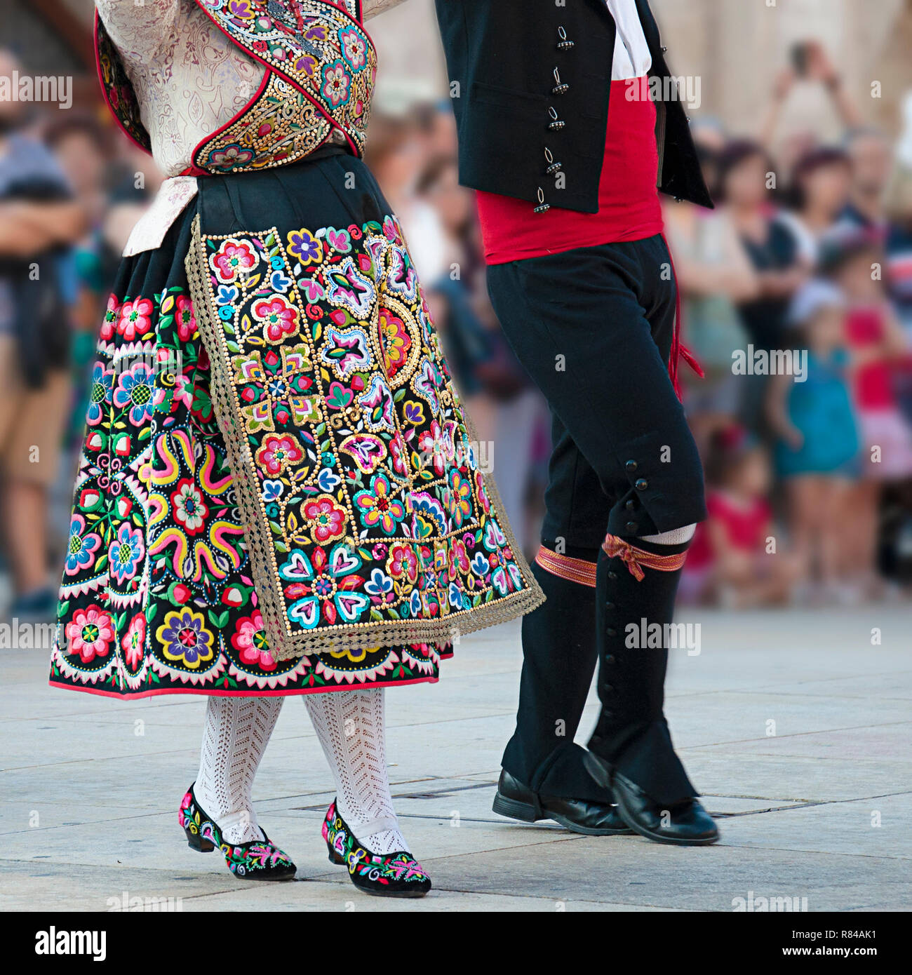 Man and woman dancing and wearing the traditional folk costume from