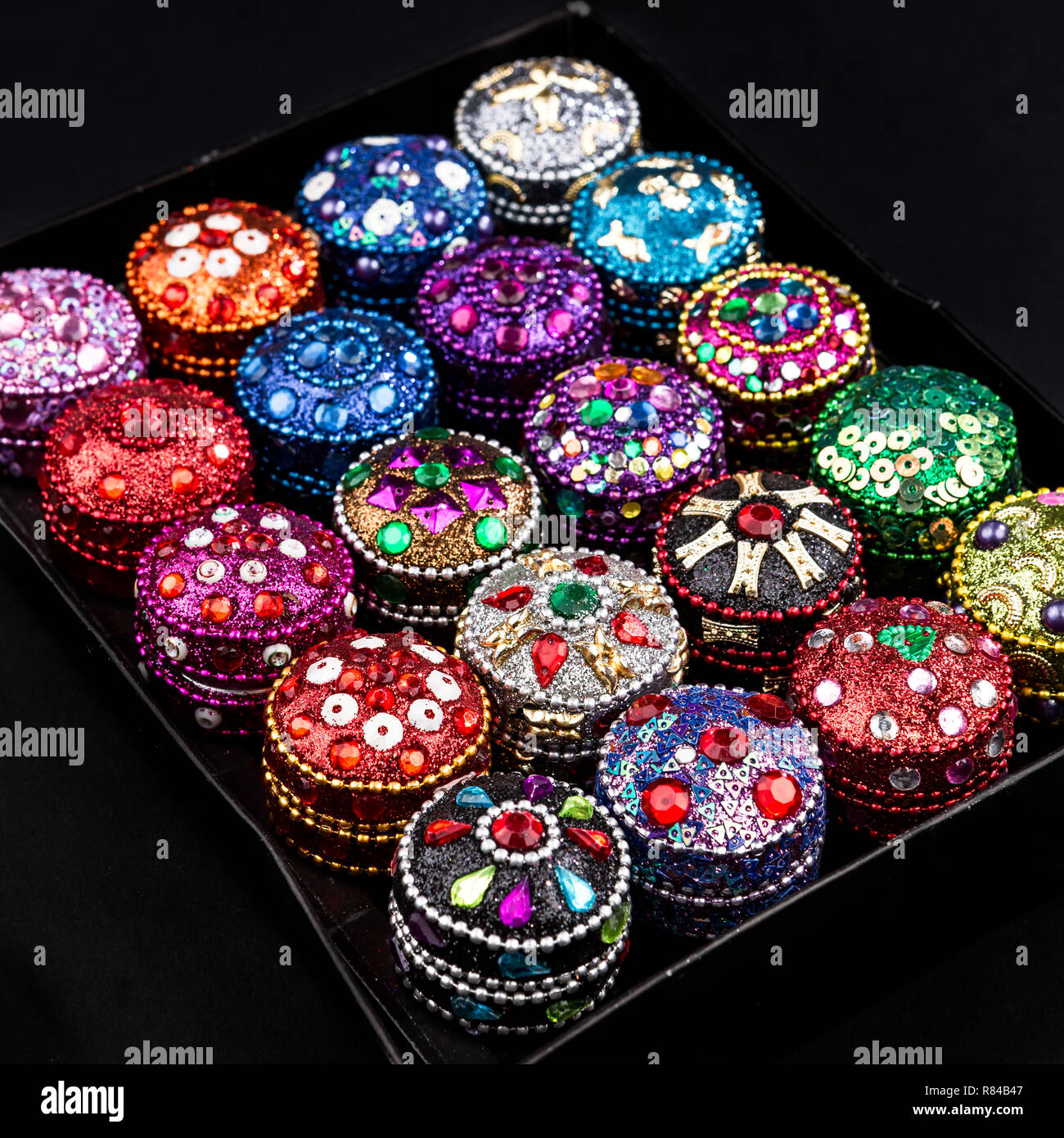 Set of Small colorful jewellery boxes decorated with glitter, sequins and  zircons on dark background Stock Photo - Alamy
