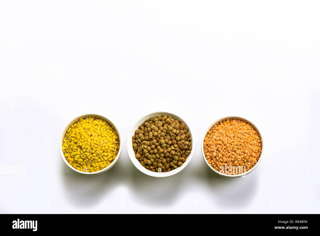 lentils are the basis of highprotein Asian and European dishes. Three bowls. Copy space. Border