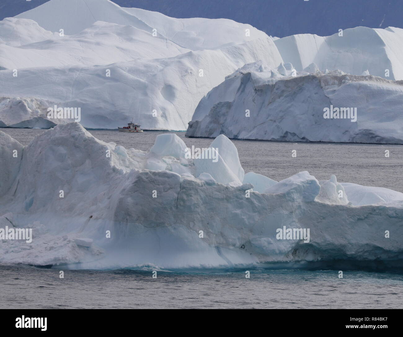 Grönland Ilulissat: Ausflugsboot zwischen den Eisbergen Stock Photo