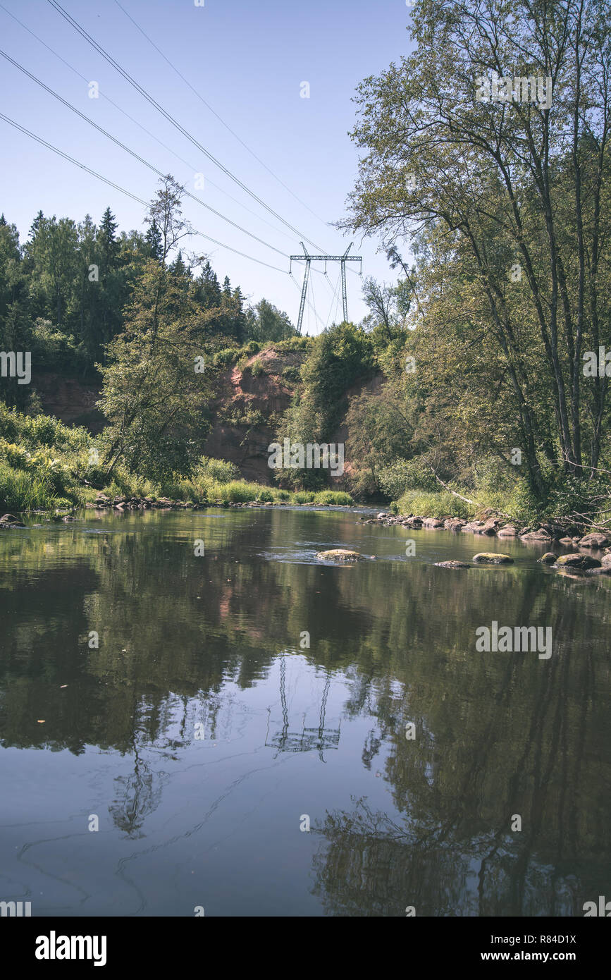 Brasla summer day on water in calm river enclosed in forests with sandstone ...