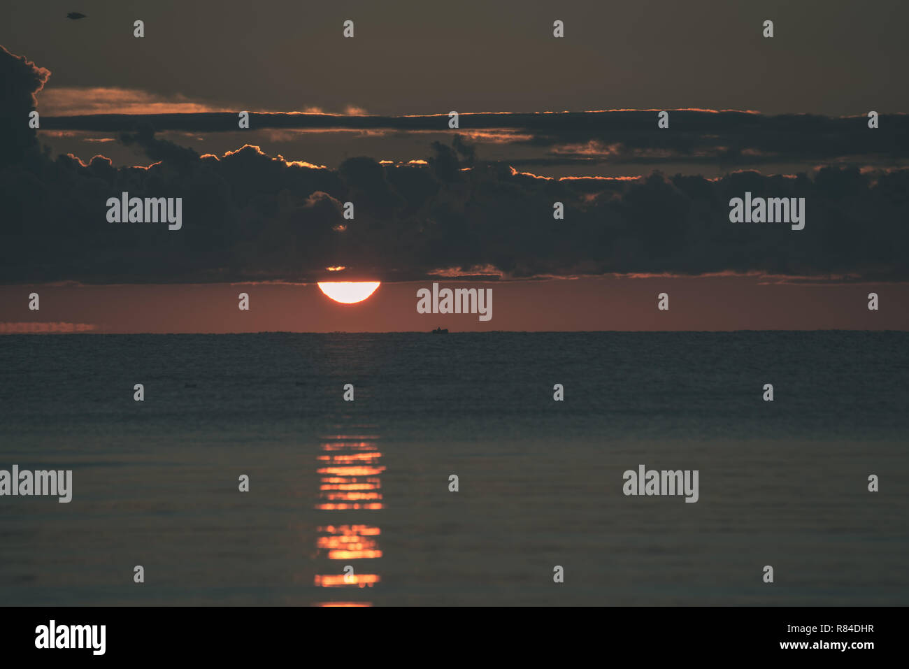 colorful sunset or sunrise in the sea with bright colors and dramatic ...