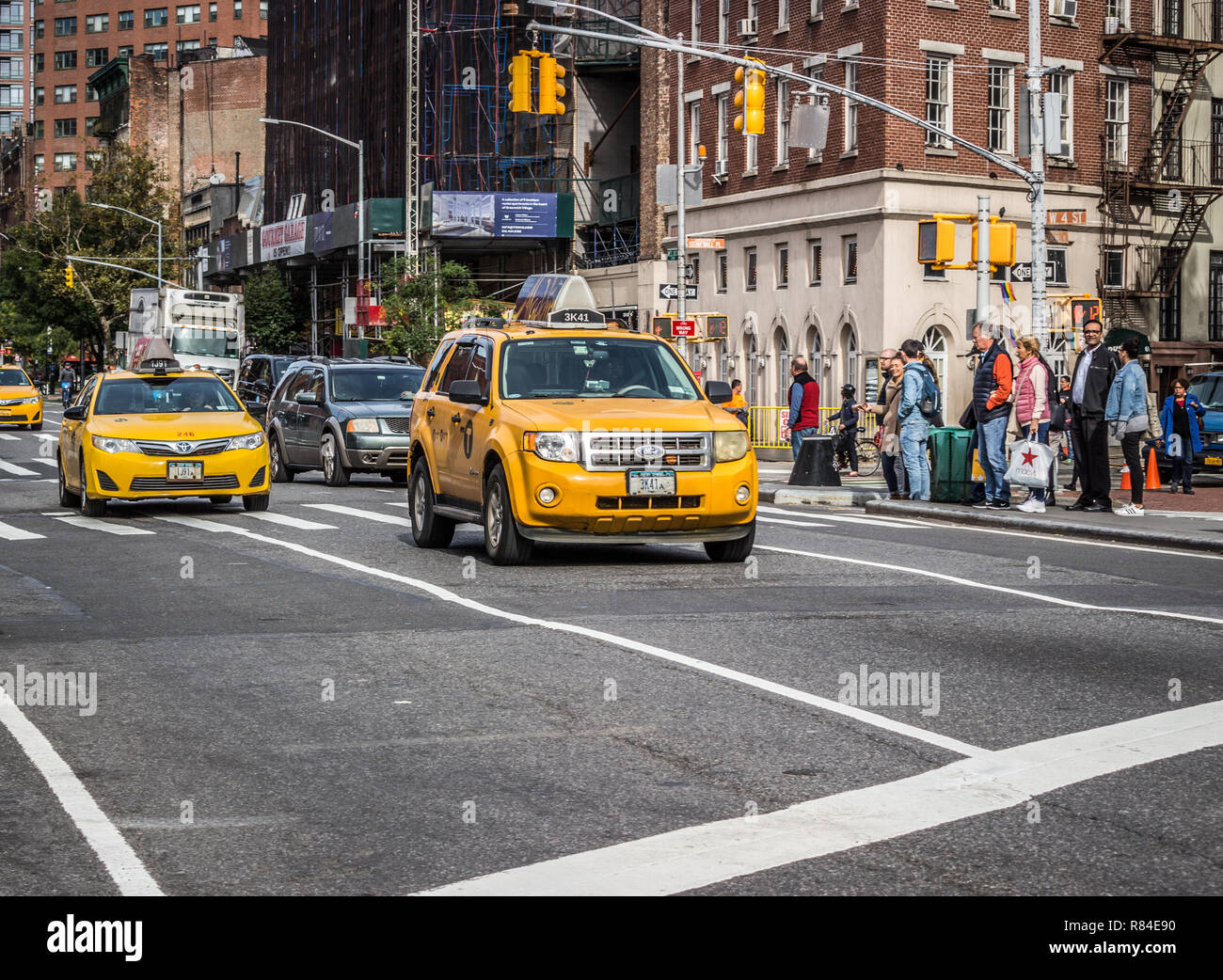 Greenwich Village, Manhattan, New York, USA, October 16 2018. Yellow New York Taxis travelling down 6th Avenue on a sunny autumn day. Stock Photo