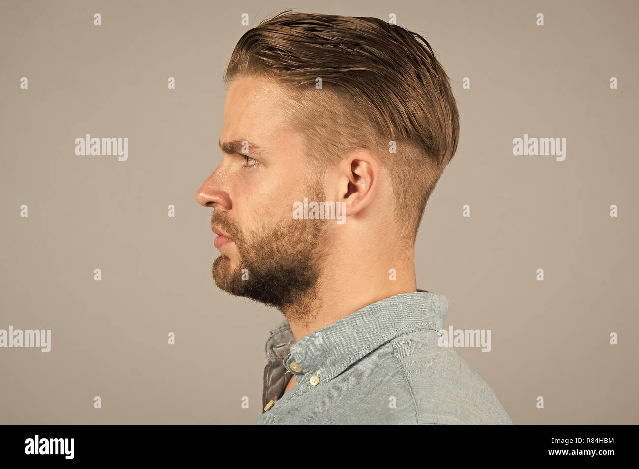 Man with bearded face in profile. Macho with beard and mustache. Guy with  stylish hair and unshaven skin. Beard grooming and hair care in barbershop.  Skincare and mens beauty concept Stock Photo -