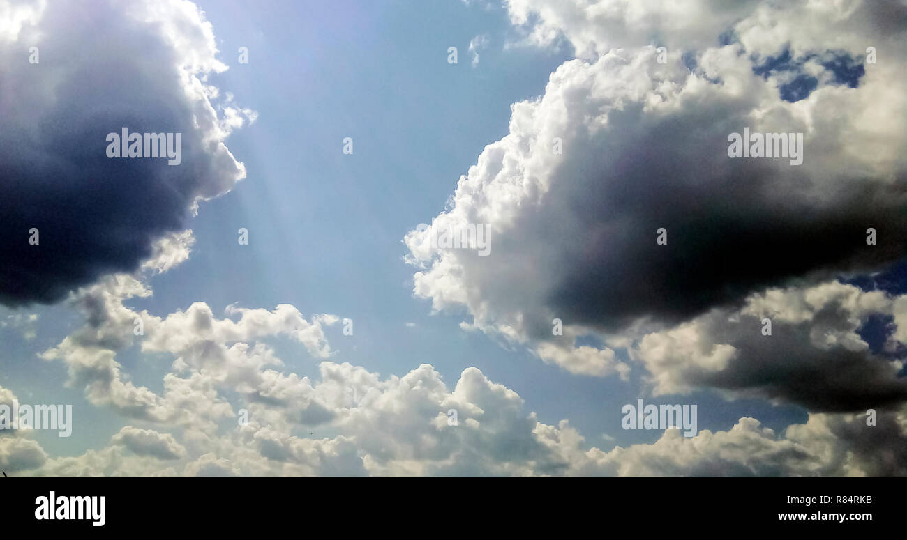 cumulus clouds like fluffy, white cotton balls on the blue sky