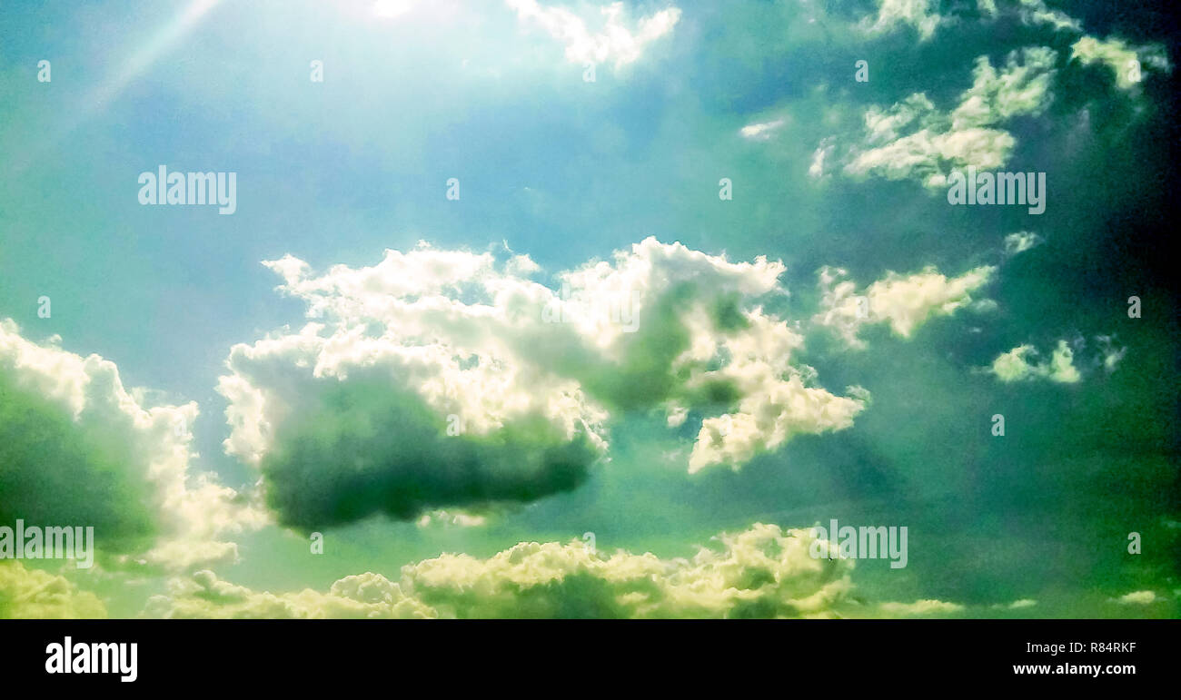 cumulus clouds like fluffy, white cotton balls on the blue sky