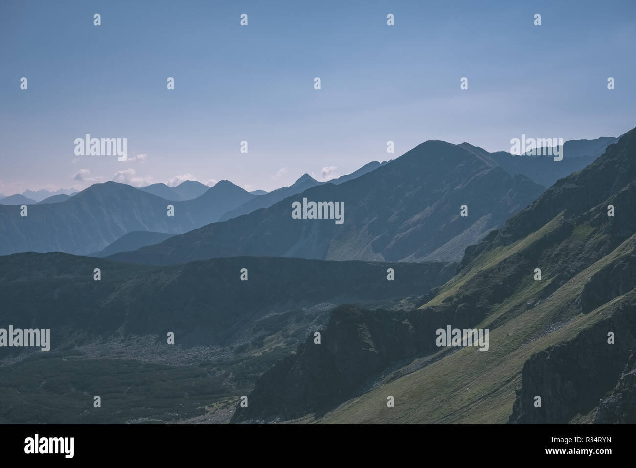 western carpathian mountain tops in autumn covered in mist or clouds ...