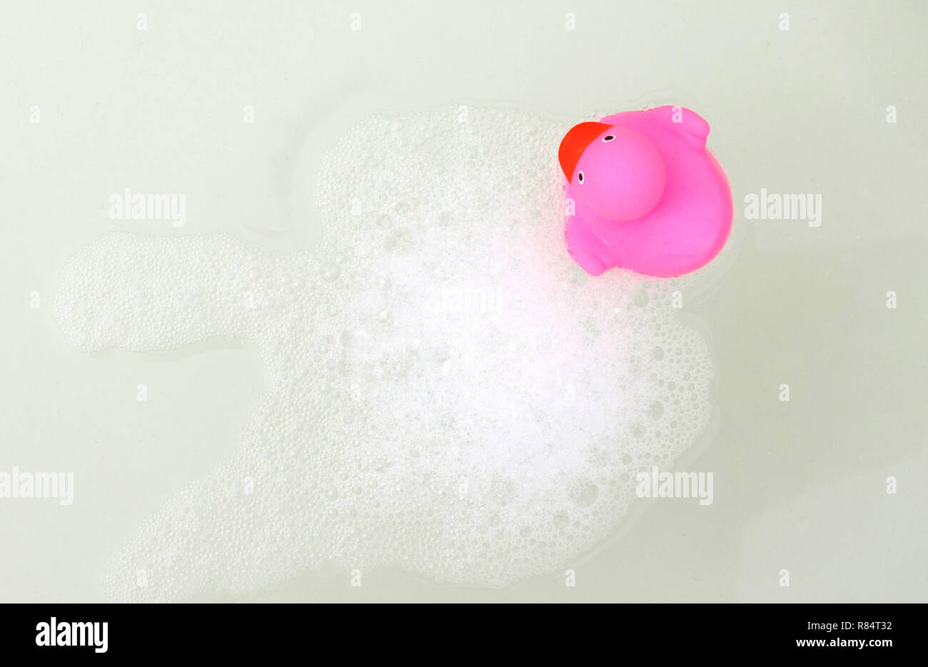 Pink duck in a bathtub, surrounded by soap Stock Photo - Alamy