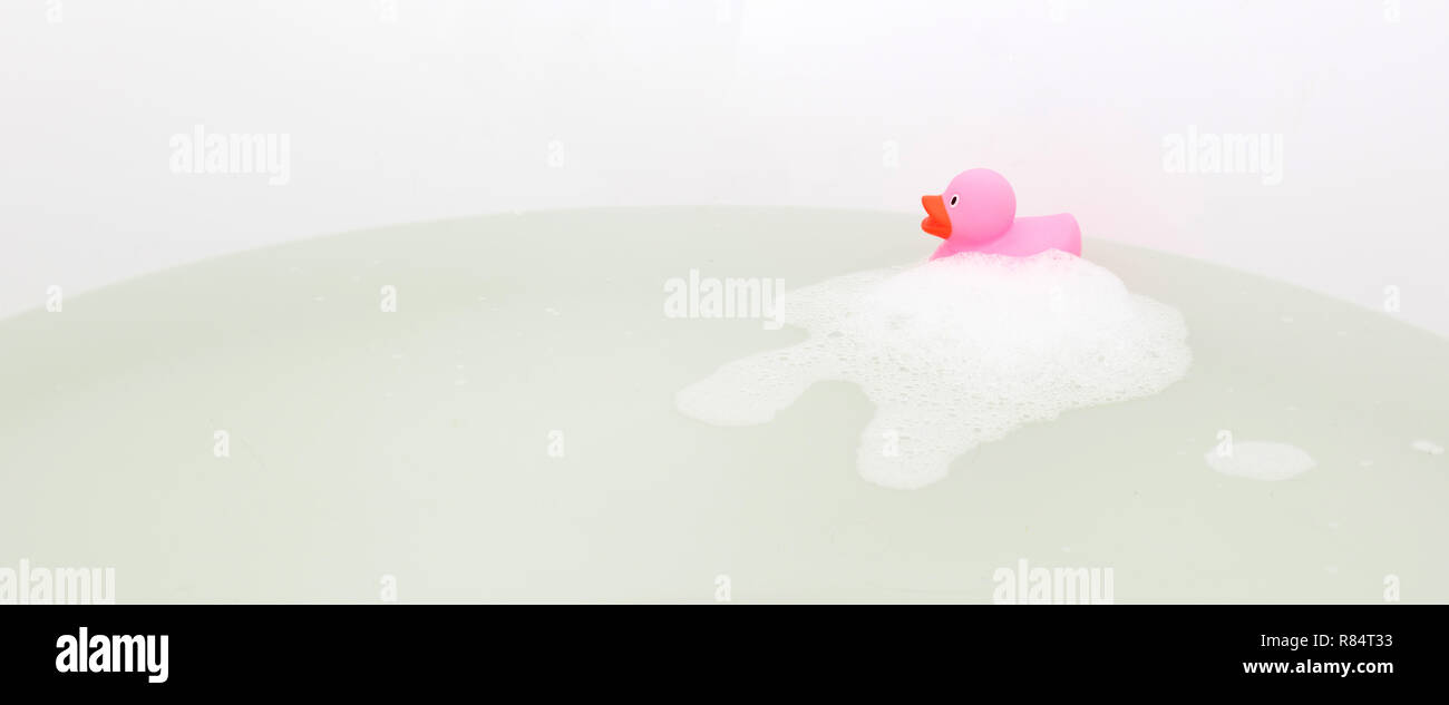Pink duck in a bathtub, surrounded by soap Stock Photo - Alamy