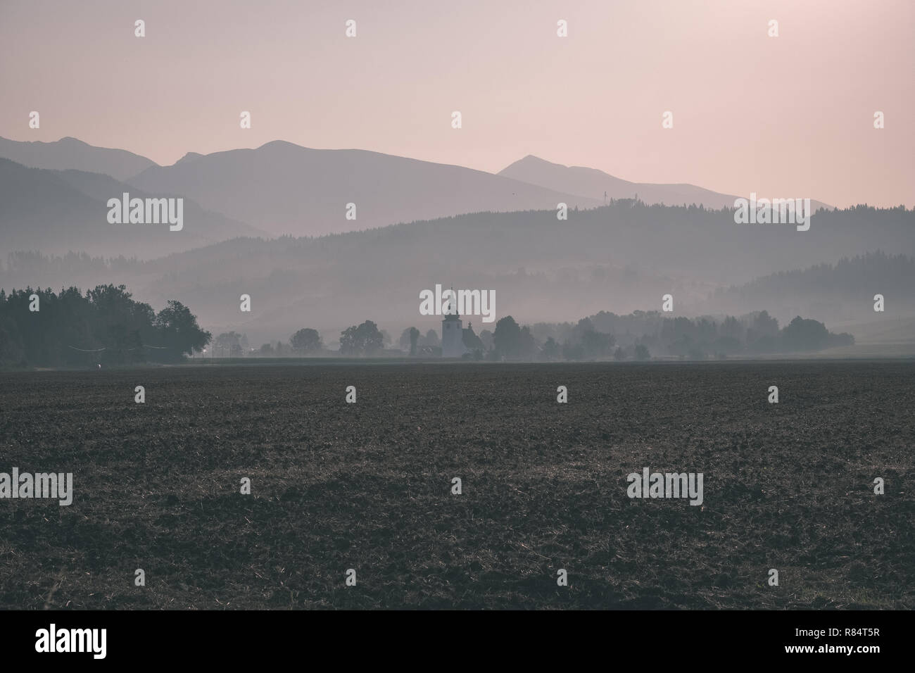 western carpathian mountain tops in autumn covered in mist or clouds ...