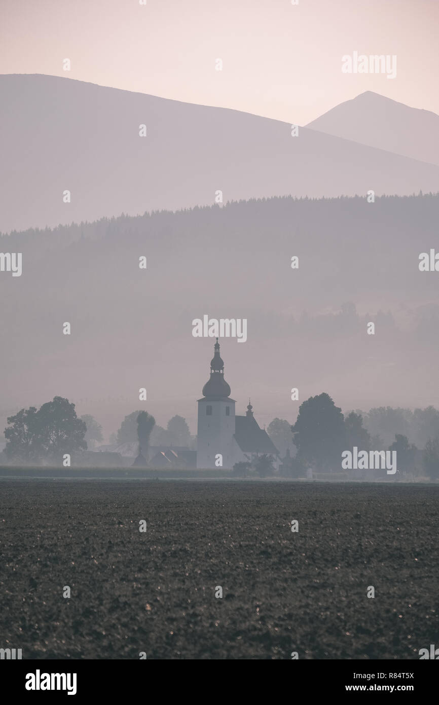 western carpathian mountain tops in autumn covered in mist or clouds ...