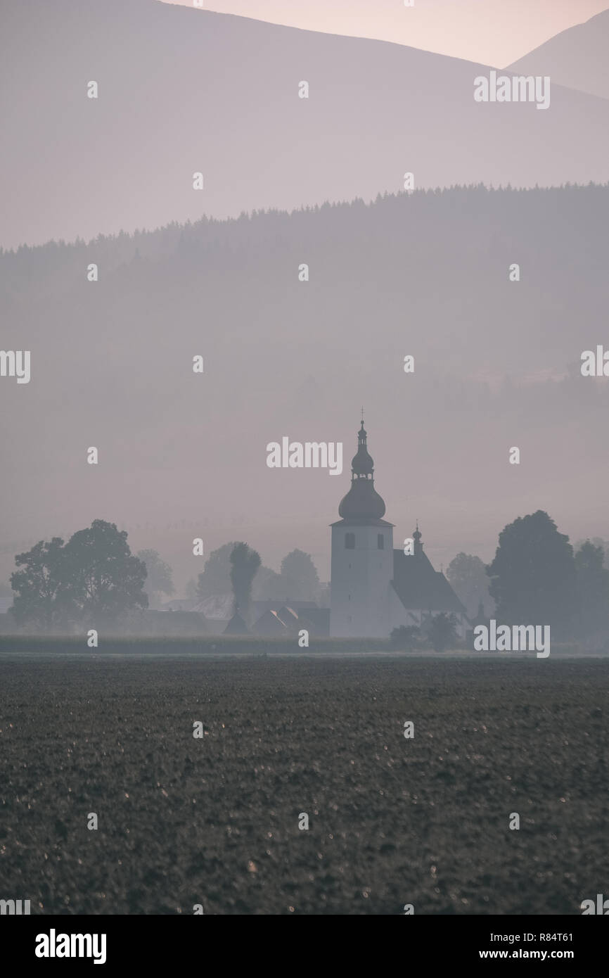 western carpathian mountain tops in autumn covered in mist or clouds ...