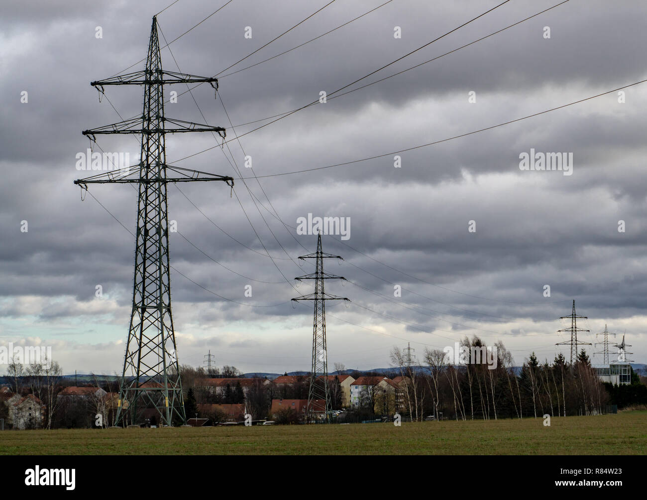 background of large high voltage electrical pole passing to the city Stock Photo