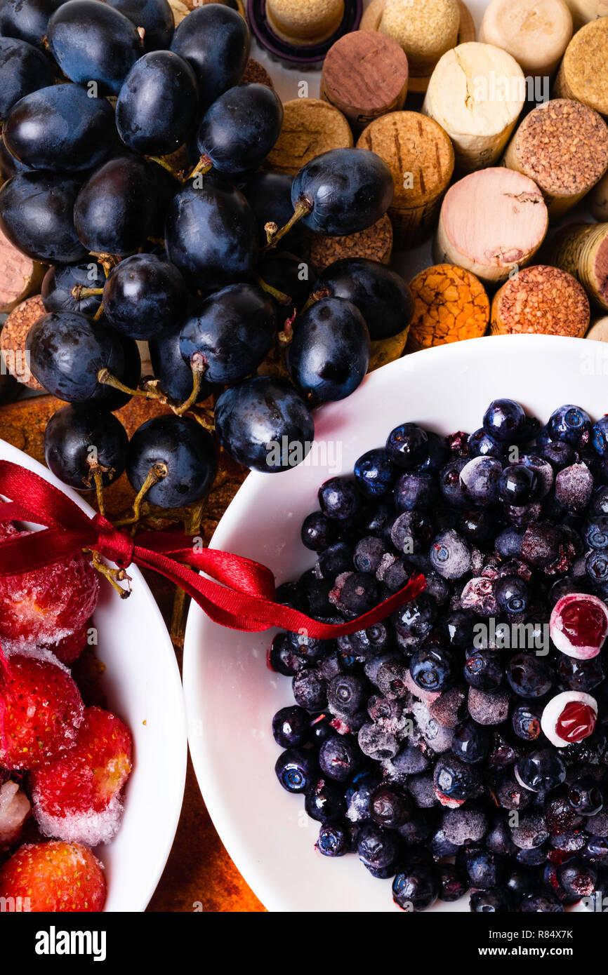 strawberry, blueberry, grape on wine corks, antioxidants, resveratrol flavonoids rich food Stock Photo