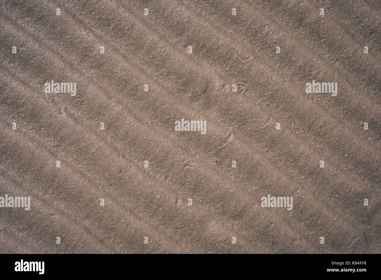 abstract texture sand pattern near water body with some plants ...