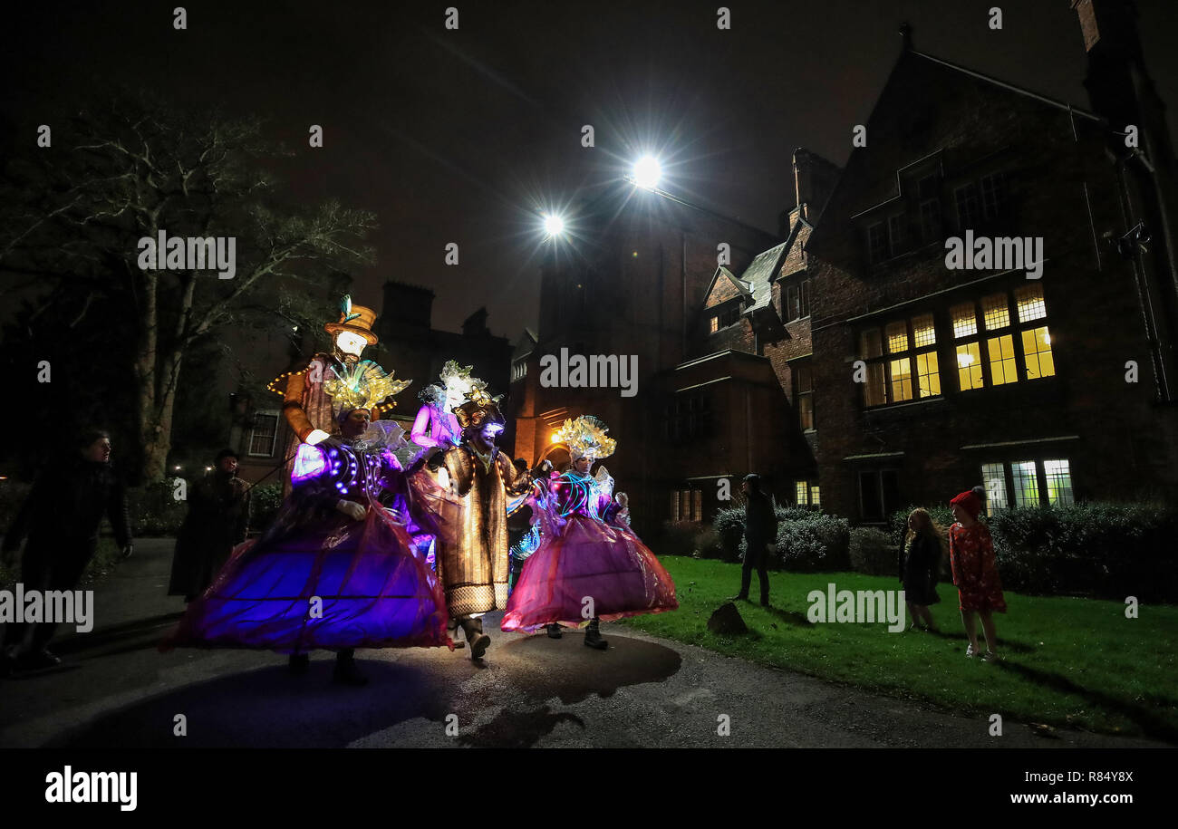 Illuminated paper puppets and human characters wearing illuminated clothing, part of The Secret Winter Garden at Croxteth Hall & Country Park, Liverpool. The show by the Lantern Company runs from December 13 to 22. Stock Photo