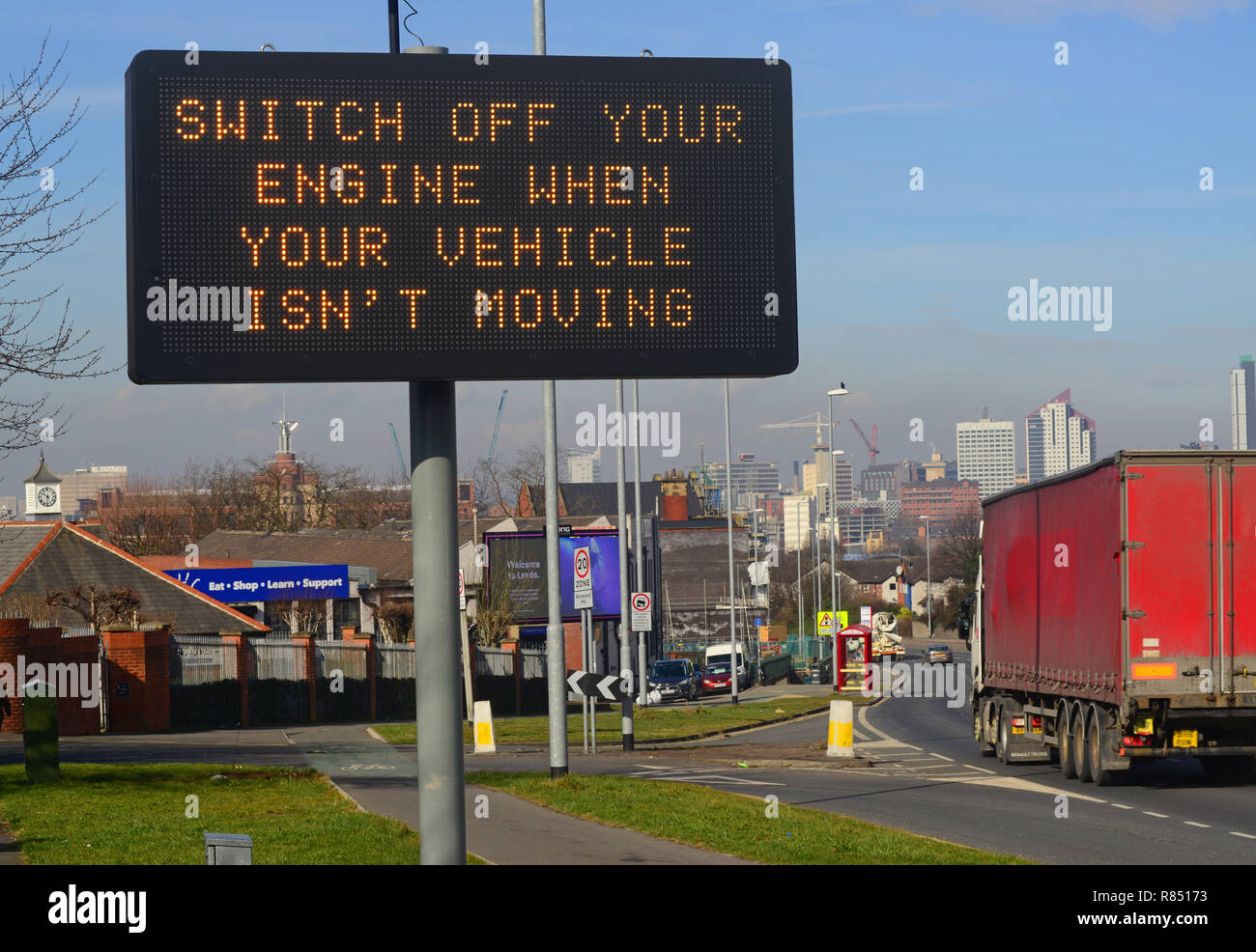 lorry passing digital road sign requesting drivers to turn off engines