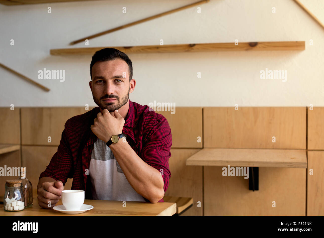 Handsome man having a coffee at the cafe Stock Photo