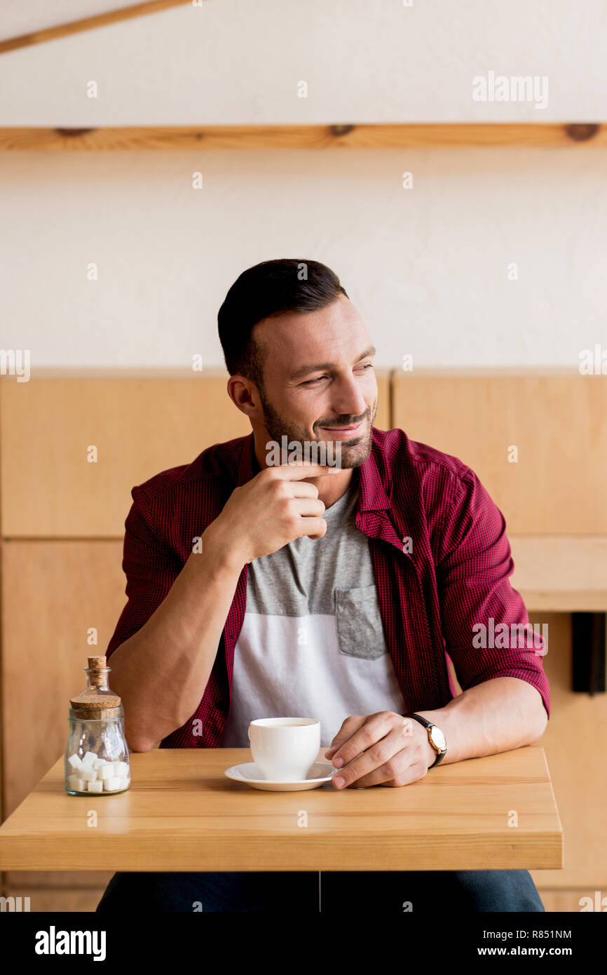 Handsome man having a coffee at the cafe Stock Photo