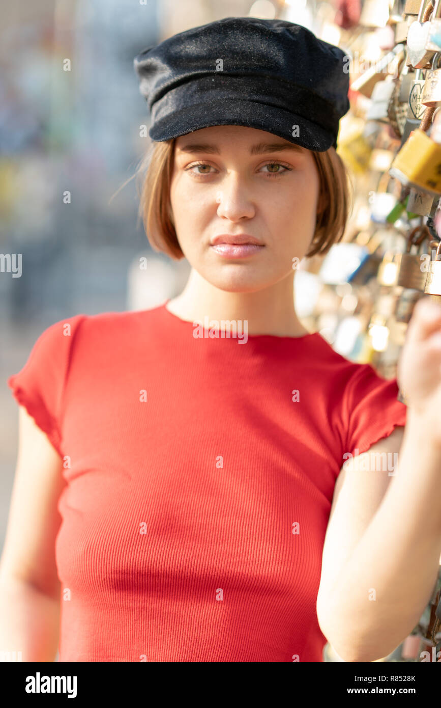 Portrait Of Young Woman With Short Hair Beanie And Red Top In The