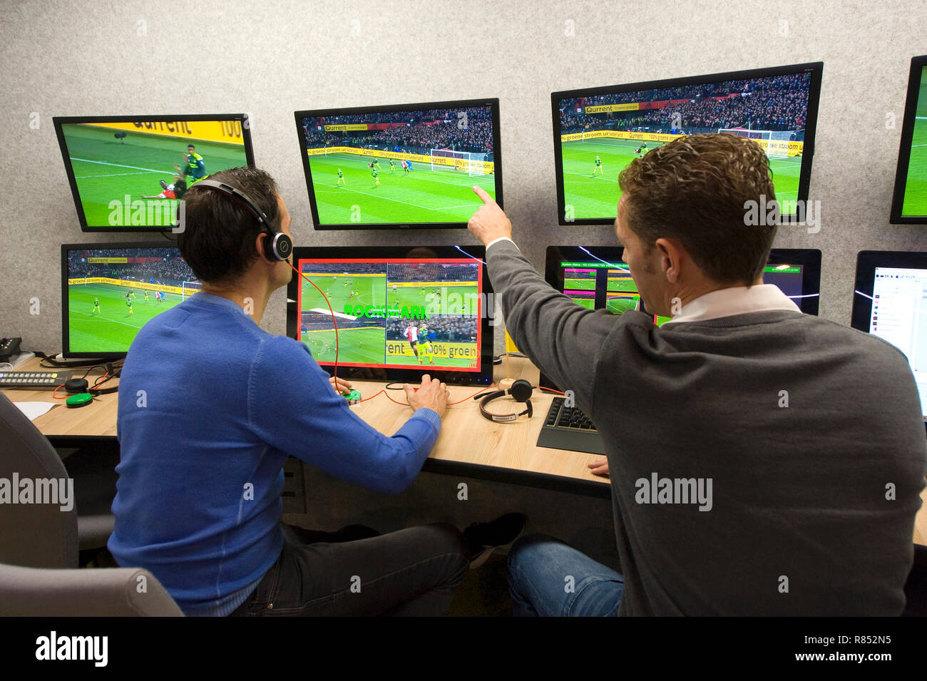 VAR referee Bas Nijhuis (left) and his operator Mike van der Roest (right) working at the VAR center in the headquarters of the Dutch football associa Stock Photo