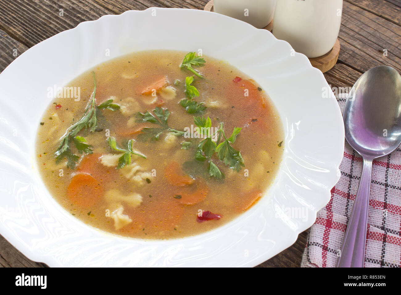 Soup with meatballs and pasta in plate on table Stock Photo
